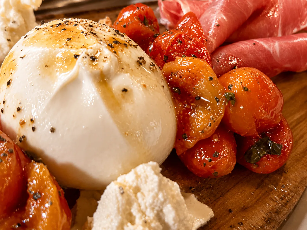 Burrata with roasted tomatoes, prosciutto and fresh ricotta