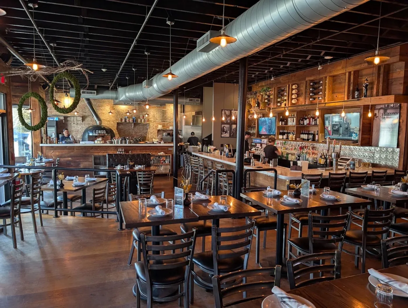 The warm, brick-walled dining room at Longo Ristorante